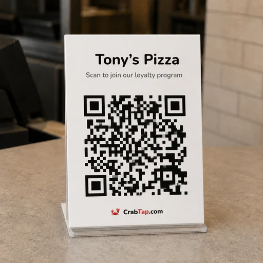 Printed CrabTap QR code sign on a counter